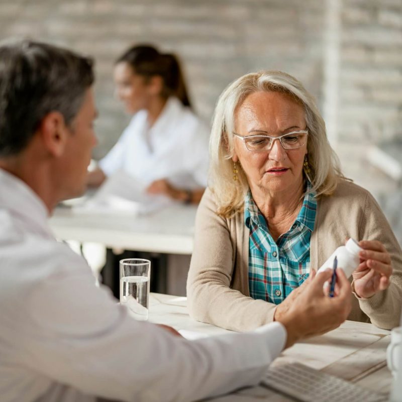 senior-woman-consulting-with-healthcare-worker-about-her-prescription-medicines-.jpg